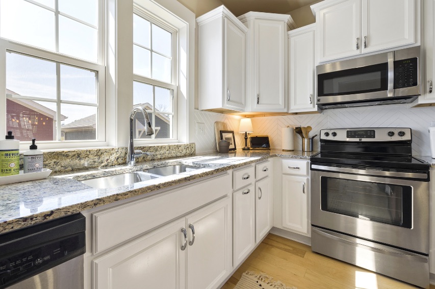 L-shaped kitchen design with granite countertops